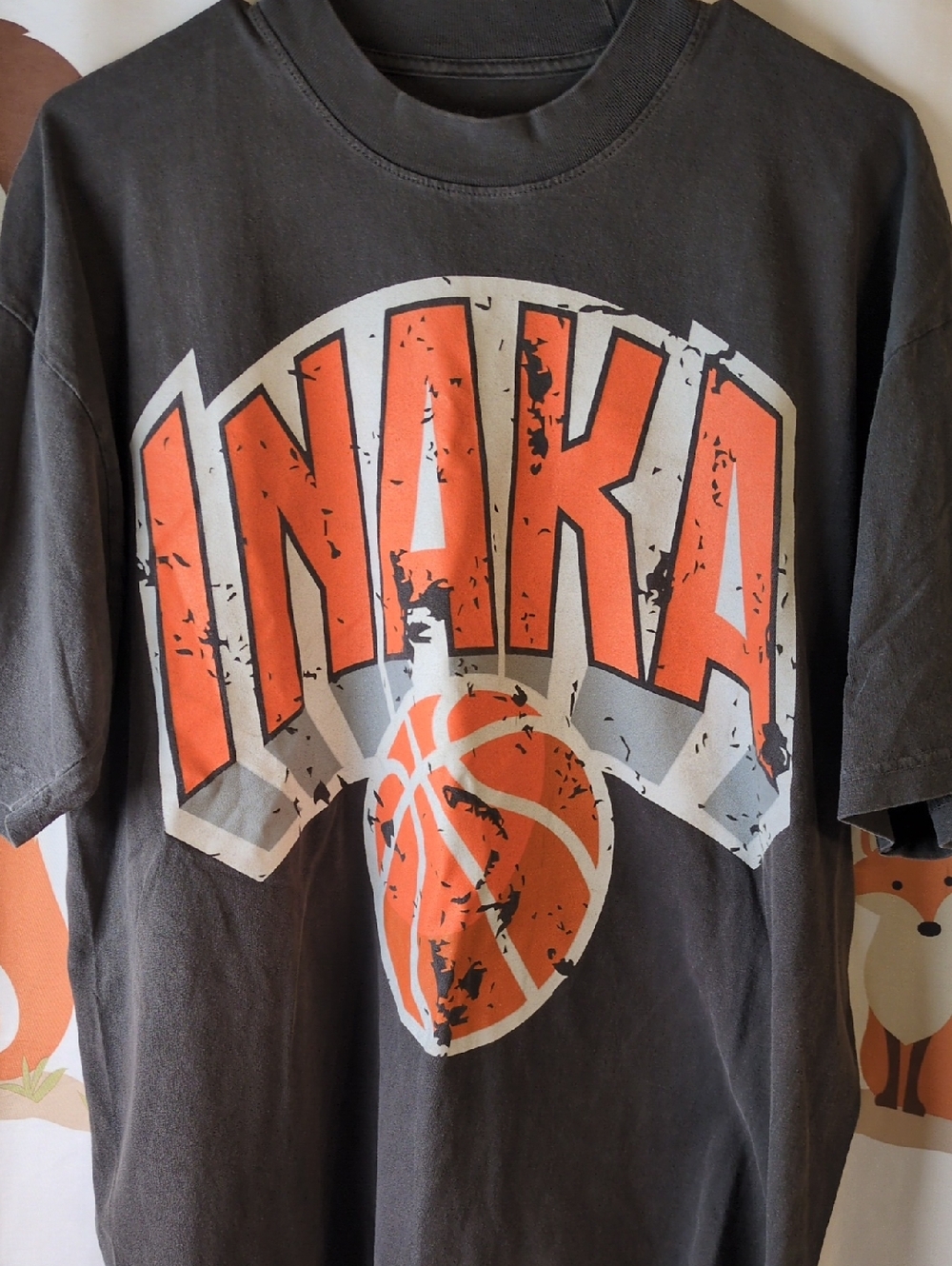 Inaka Power Black Short-Sleeve Tee with Orange Graphic